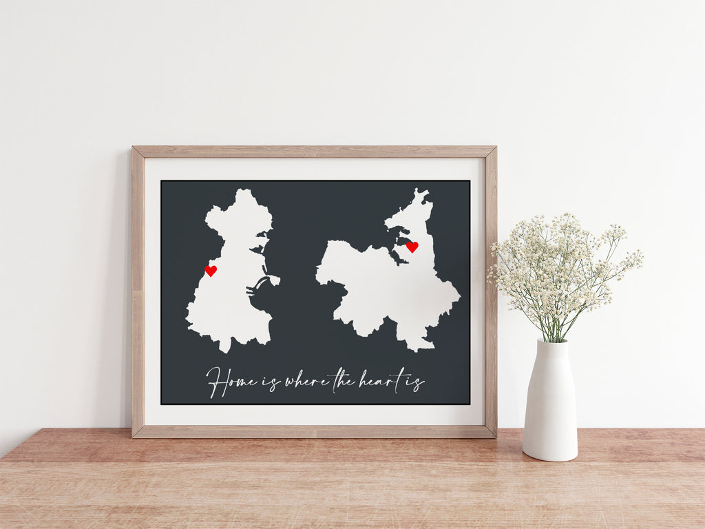 Home is where the heart is grey print with white county and country outlines, red hearts sitting on a console with baby breath flowers