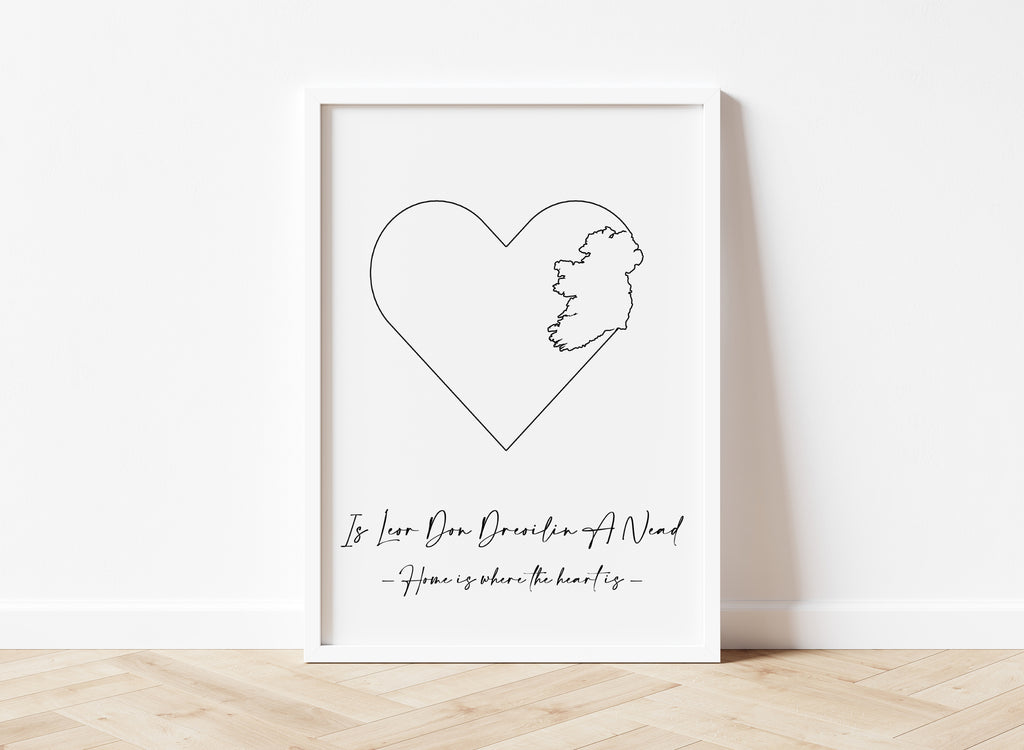 white print featuring black ireland map outline in heart with phrase ''home is where the heart is'' and Irish phrase Is leor don dreoilín a nead